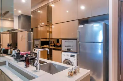 a kitchen with a stainless steel refrigerator and a dishwasher at Dorsett Bukit Bintang 5min to Pavilion KL in Kuala Lumpur