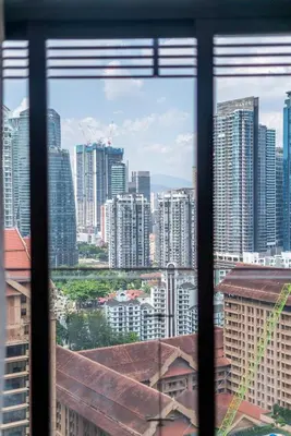 a view of a city skyline from a window at Dorsett Bukit Bintang 5min to Pavilion KL in Kuala Lumpur