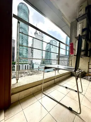 a chair in front of a window with a view at Parkview 2bedroom apartment klcc in Kuala Lumpur