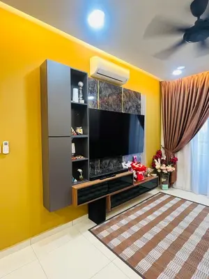 a living room with a flat screen tv on a yellow wall at Vista Sentul Residence in Kuala Lumpur