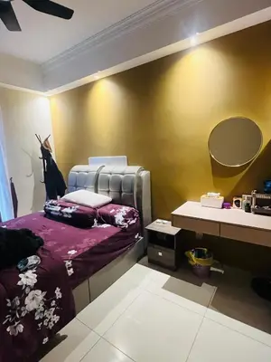 a bedroom with a bed and a desk with a mirror at Vista Sentul Residence in Kuala Lumpur