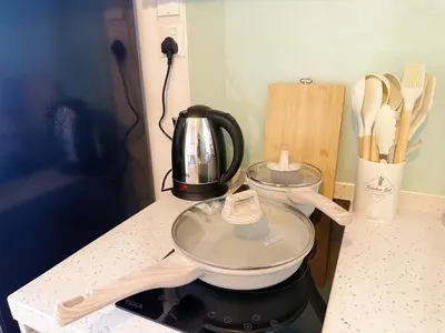 a kitchen counter with a tea pot on a stove at Cozy Studio I Riveria City I 1km to KL Sentral in Kuala Lumpur