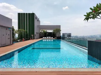 a swimming pool on the roof of a building at Cozy Studio I Riveria City I 1km to KL Sentral in Kuala Lumpur