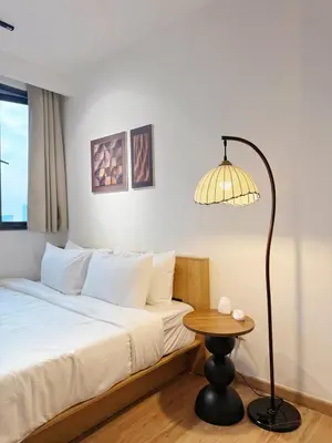 a bedroom with a bed with a lamp and a table at Cozy Studio I Riveria City I 1km to KL Sentral in Kuala Lumpur