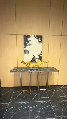 a table in a room with a painting on the wall at Majestic Alaman Suites KLCC in Kuala Lumpur