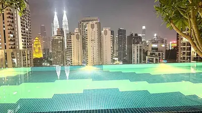 a swimming pool with a view of a city at Majestic Alaman Suites KLCC in Kuala Lumpur