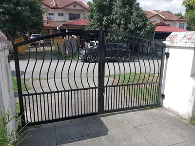 a black gate with a car parked in a driveway at have fun staying here in Kuala Lumpur