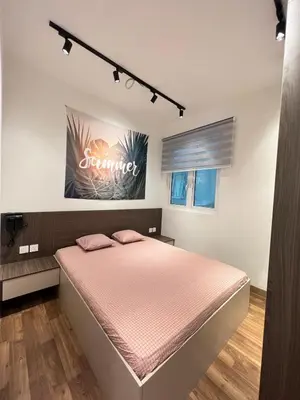 a bedroom with a bed with a pink bedspread at Relax and Enjoy ! in Kuala Lumpur