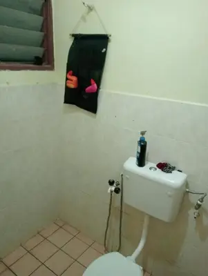 a bathroom with a toilet and a bag on the wall at have fun staying here in Kuala Lumpur