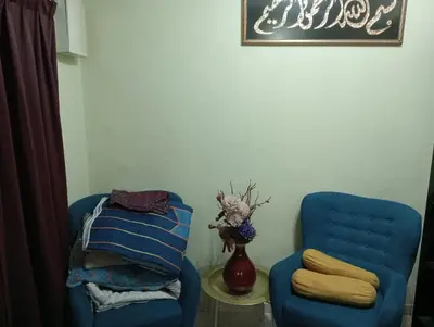 a room with two blue chairs and a vase at have fun staying here in Kuala Lumpur