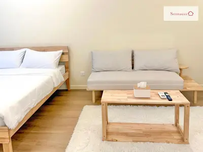 a bedroom with two beds and a coffee table at KLCC View & Netflix & Walk to LRT & Sunway Putra in Kuala Lumpur