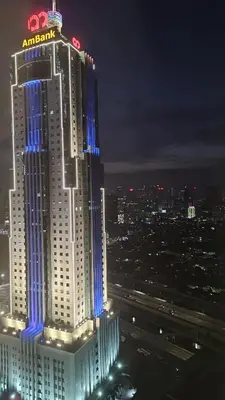 a large building with blue lights on it at night at Star Residence KLCC By LLKOK in Kuala Lumpur