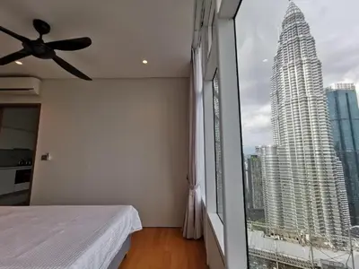 a bedroom with a bed and a large window at Sky Suites in Kuala Lumpur