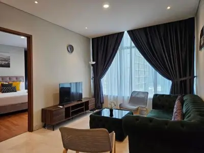 a living room with a couch and a television at Sky Suites in Kuala Lumpur
