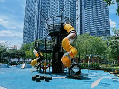a slide in a playground in a park at M VERTICA Isyak Homestay in Kuala Lumpur