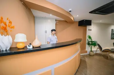 a man standing behind a counter in a room at Swing & Pillows - Sungei Wang Bukit Bintang in Kuala Lumpur