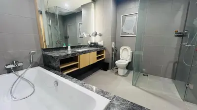 a bathroom with a tub and a sink and a toilet at KLCC Luxury 2BR 188 Suites in Kuala Lumpur