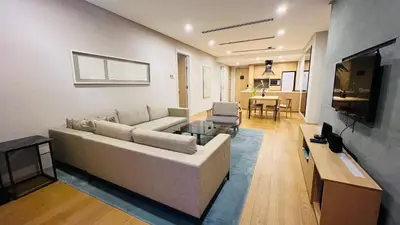 a living room with a couch and a tv at KLCC Luxury 2BR 188 Suites in Kuala Lumpur