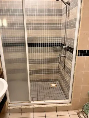 a shower with a glass door in a bathroom at Seri Bukit Ceylon Bukit Bintang in Kuala Lumpur