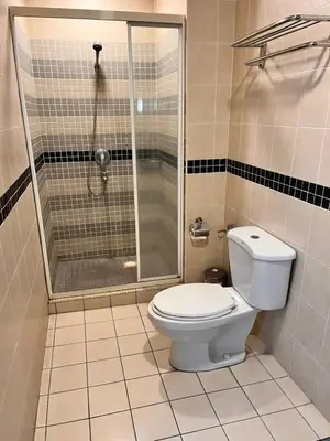 a bathroom with a shower and a toilet at Seri Bukit Ceylon Bukit Bintang in Kuala Lumpur