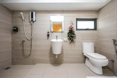 a bathroom with a shower and a toilet and a sink at Heaven Suites KL in Kuala Lumpur