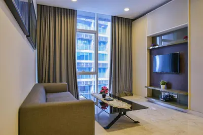 a living room with a couch and a tv at Sama Suites at Platinum KLCC Bukit Bintang in Kuala Lumpur