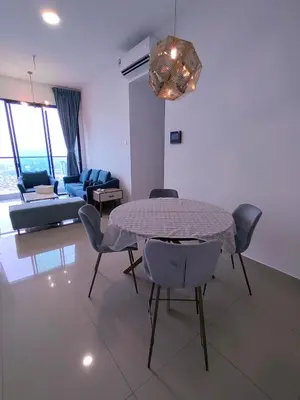 a living room with a table and chairs and a couch at Service Apartment Sunway Velocity in Kuala Lumpur