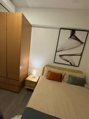 a bedroom with a large bed and a dresser at Agile Milestone service suite TRX by KL in Kuala Lumpur