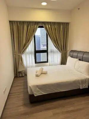 a bedroom with a large bed with a window at Agile Milestone service suite TRX by KL in Kuala Lumpur