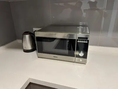 a microwave sitting on top of a counter at Agile Milestone service suite TRX by KL in Kuala Lumpur