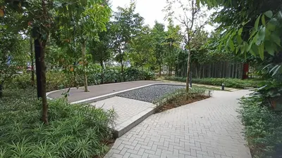 a brick walkway in a park with trees at Agile Milestone service suite TRX by KL in Kuala Lumpur