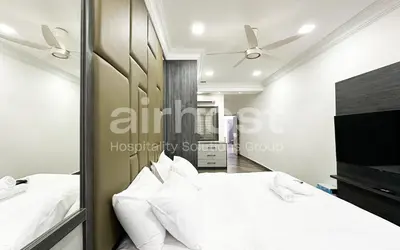 a bedroom with two beds and a flat screen tv at Family House at Setiawangsa by Airhost in Kuala Lumpur