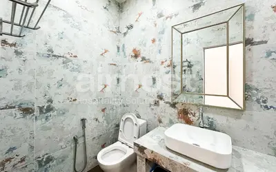 a bathroom with a toilet and a sink and a mirror at Family House at Setiawangsa by Airhost in Kuala Lumpur