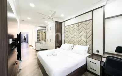 a bedroom with a large white bed and a television at Family House at Setiawangsa by Airhost in Kuala Lumpur
