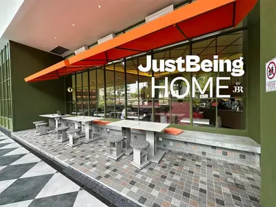 a restaurant with tables in front of a building at Just Being Home 4pax 1BR 1BA 1Queen 1Sofa in Kuala Lumpur