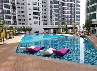 a large swimming pool with two purple and white chairs at Setapak KL Apt 2 Room Mus'lim in Kuala Lumpur