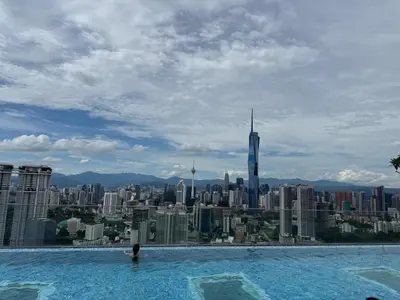 a swimming pool with a view of a city at KL Sentral city retreats with KLCC views in Kuala Lumpur