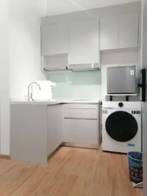 a kitchen with white cabinets and a sink and a dishwasher at KL Sentral city retreats with KLCC views in Kuala Lumpur