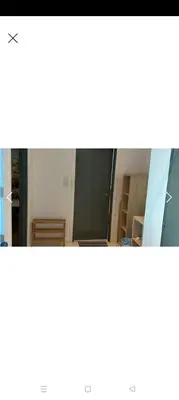 two pictures of a room with a mirror at Summer Suites By SmartWill in Gua Sai