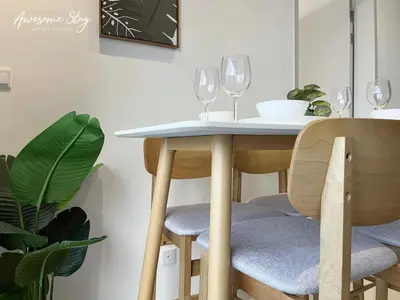 a dining room table with chairs and wine glasses at Trion KL By The Relaxstay in Kuala Lumpur