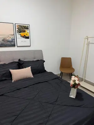a bedroom with a bed and a chair and flowers at Razak City Kuala Lumpur A2-30 in Kuala Lumpur