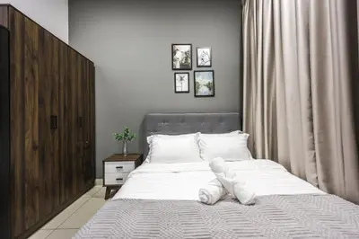a bedroom with a bed with white towels on it at Trion Kuala Lumpur by Vivid Stay in Kuala Lumpur
