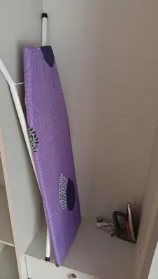 a purple surfboard hanging from the side of a stairs at Quill Residence- Minimalist Urban Condo by Azmila in Kuala Lumpur