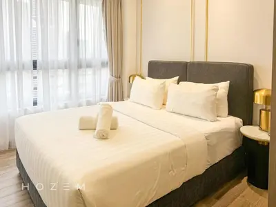 a bedroom with a large bed with white sheets and pillows at SBR1B Hozem KL2601 Apartment Bukit Bintang in Kuala Lumpur