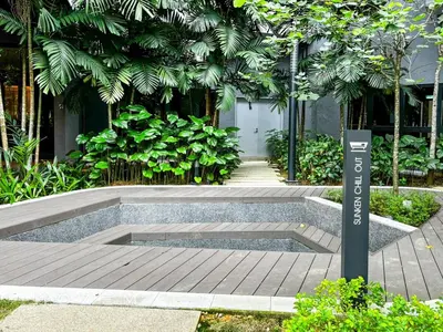 a bench in a garden with a sign on it at SBR1B Hozem KL2601 Apartment Bukit Bintang in Kuala Lumpur