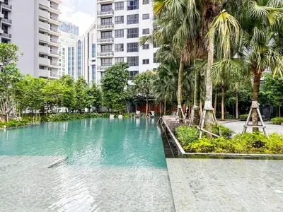 a large swimming pool with palm trees and buildings at 2BR2B Hozem KL2708 Apartment Bukit Bintang in Kuala Lumpur
