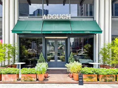 a store front with a green awning and plants at 2BR2B Hozem KL1812 Apartment Bukit Bintang in Kuala Lumpur