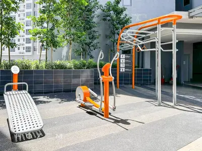 an orange exercise machine and a bench in front of a building at 2BR2B Hozem KL4906 Apartment Bukit Bintang in Kuala Lumpur