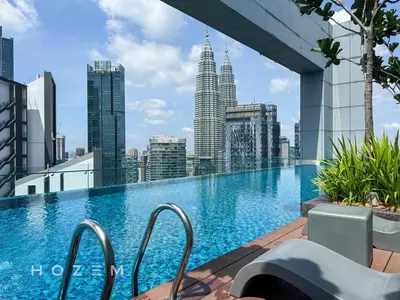 a swimming pool on the roof of a building with a city skyline at 2BR2B Hozem KL2903 Apartment KLCC in Kuala Lumpur
