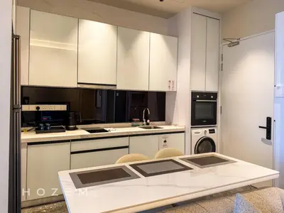 a kitchen with white cabinets and a white table at 2BR2B Hozem KL3802 Apartment KLCC in Kuala Lumpur